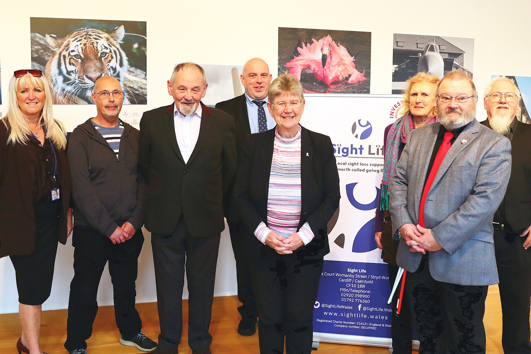 Michelle & Richard standing in the gallery with Jane Hutt and a few of the photography group at the launch.
